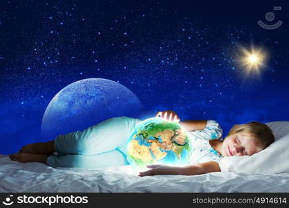 Good night. Girl in bed with Earth planet in hands. Elements of this image are furnished by NASA