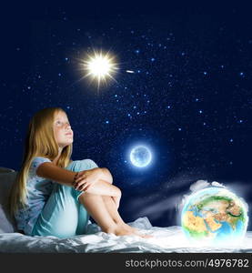 Good night. Girl sitting in bed and dreaming. Elements of this image are furnished by NASA