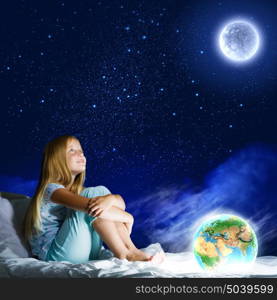 Good night. Girl sitting in bed and dreaming. Elements of this image are furnished by NASA