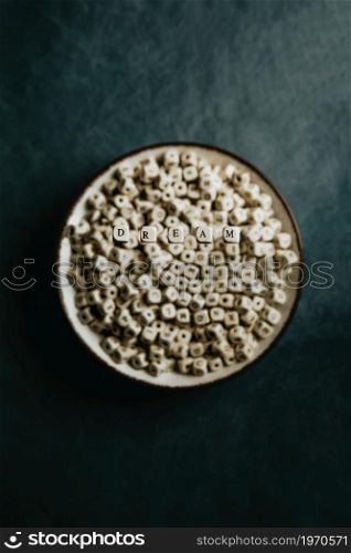 Good vibes and dream and inspiration concept shot, white dices over a cup , dark moody tones, lifestyle selective focus