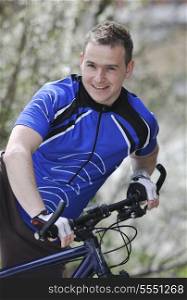 goodlooking young and healthy man portrait while hold pro mount bike bicycle outdoor in nature