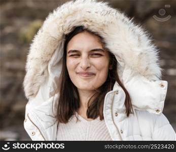 goofy woman beach posing with winter jacket