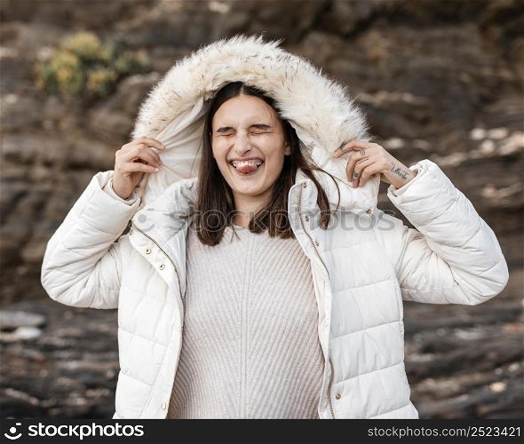 goofy woman beach with winter jacket