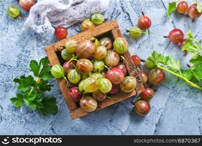 gooseberry in wooden box and on a table