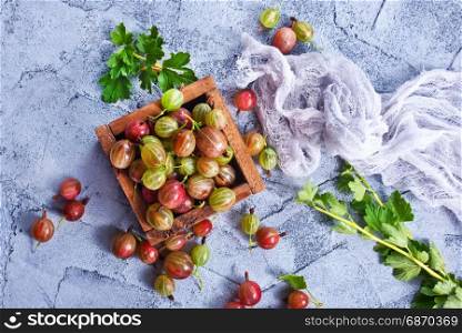 gooseberry in wooden box and on a table