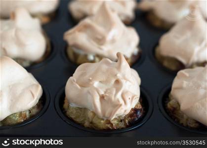 Gooseberry meringue cupcakes or muffins still in baking mould