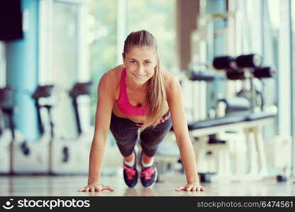 Gorgeous blonde woman warming up and doing some push ups a the gym. warming up and doing some push ups a the gym