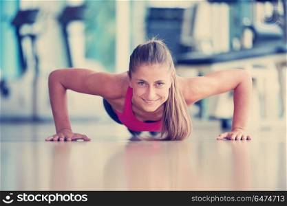 Gorgeous blonde woman warming up and doing some push ups a the gym. warming up and doing some push ups a the gym