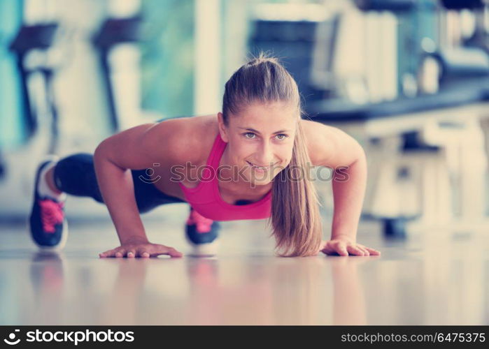 Gorgeous blonde woman warming up and doing some push ups a the gym. warming up and doing some push ups a the gym