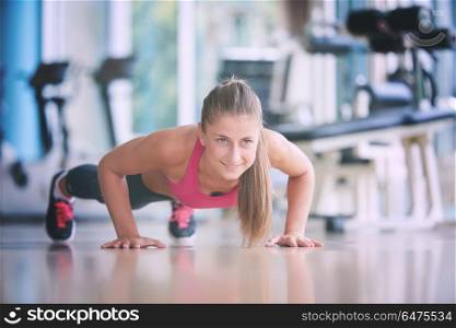 Gorgeous blonde woman warming up and doing some push ups a the gym. warming up and doing some push ups a the gym