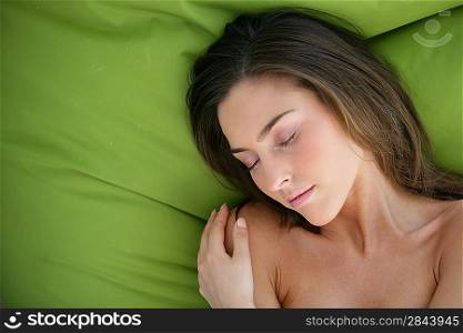 gorgeous brunette hugging herself while sleeping