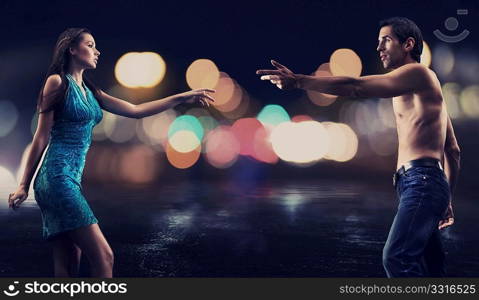 Gorgeous couple over night city street background