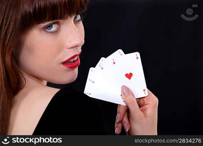 Gorgeous girl showing four aces