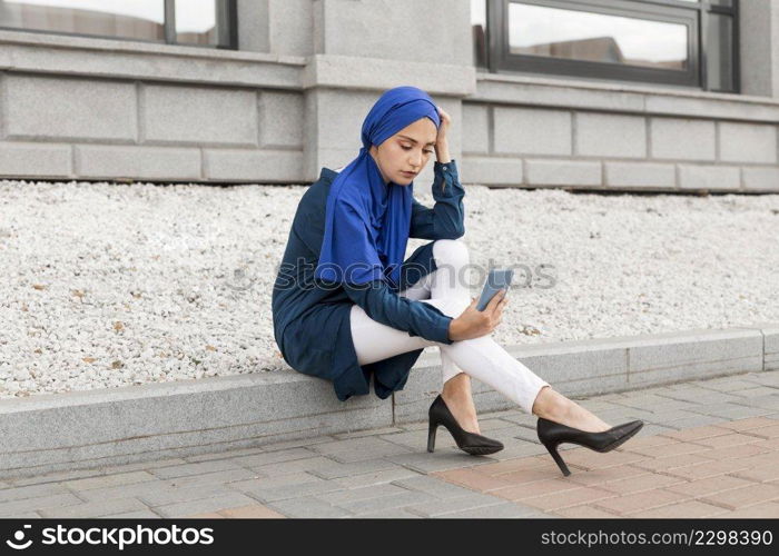 gorgeous girl with hijab taking selfie outdoors