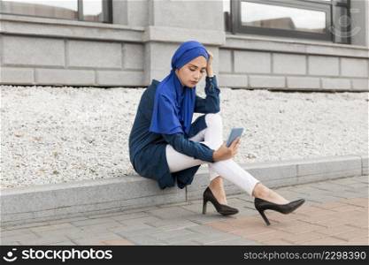 gorgeous girl with hijab taking selfie outdoors