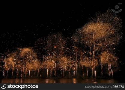 Gorgeous multi-colored light show and fireworks display on dark night sky over the river
