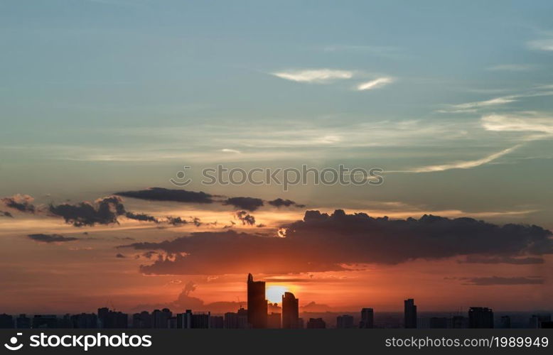 Gorgeous panorama scenic of the sunrise with cloud on the orange sky over large metropolitan city in Bangkok. Copy space, Selective focus.