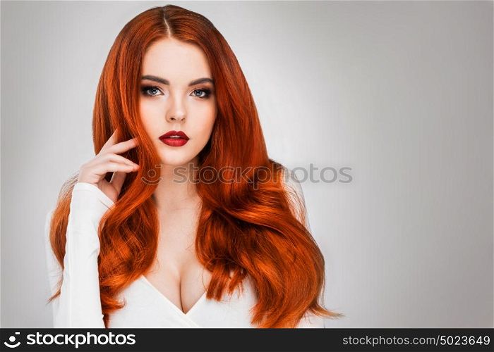 Gorgeous redhead girl. Gorgeous redhead girl with wavy hair beauty studio portrait