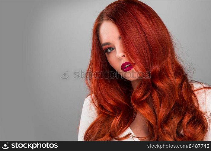 Gorgeous redhead model girl. Beauty portrait of woman. Gorgeous sensual attractive pretty redhead sexy model girl, shiny wavy hair.