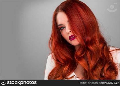 Gorgeous redhead model girl. Beauty portrait of woman. Gorgeous sensual attractive pretty redhead sexy model girl, shiny wavy hair.