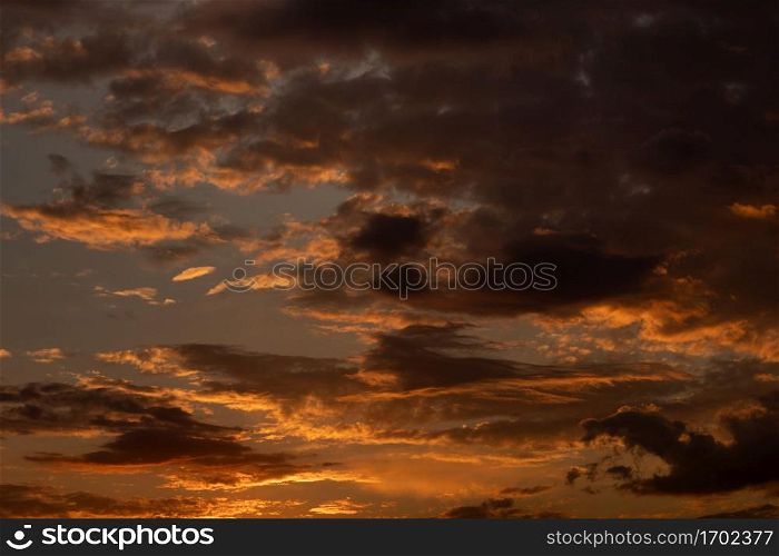 Gorgeous scenic of the sunrise or sunset with dark lining and cloud on the orange sky. Vibrant and Colorful background.. Gorgeous scenic of the sunrise or sunset with dark lining and cloud on the orange sky. Vibrant and Colorful background