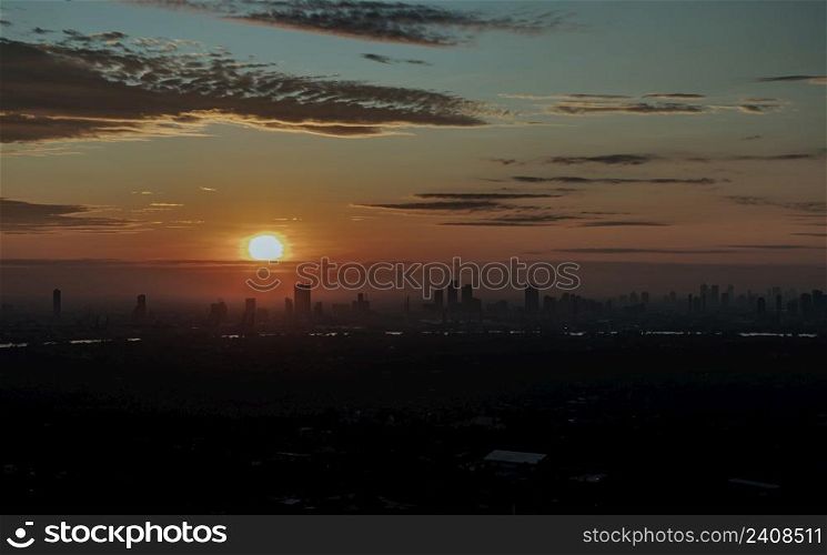 Gorgeous scenic of the sunrise sky with cloud on the orange sky over large metropolitan city in Bangkok. Travel attraction in Thailand, Space for text, No focus, specifically.