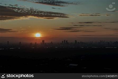 Gorgeous scenic of the sunrise sky with cloud on the orange sky over large metropolitan city in Bangkok. Travel attraction in Thailand, Space for text, No focus, specifically.