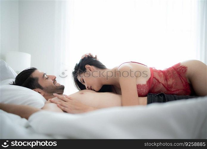 Gorgeous sexy couple enjoying arousing sex before having sex on bed in home bedroom The concept of emotional and love relationships.