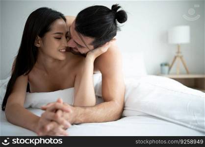 Gorgeous sexy couple enjoying arousing sex before having sex on bed in home bedroom The concept of emotional and love relationships.