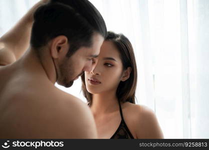 Gorgeous sexy couple enjoying sex in the house’s bedroom, Concept of as emotional relationships passion and love