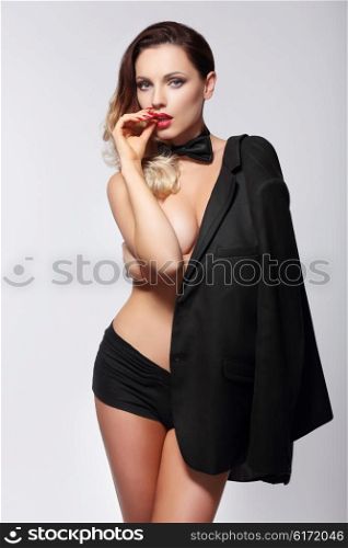 Gorgeous sexy woman in black jacket and tie. Isolated.