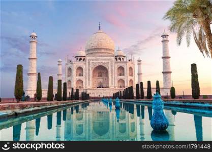Gorgeous Taj Mahal behind the palm tree, symbol of India, Agra, Uttar Pradesh.. Gorgeous Taj Mahal behind the palm tree, symbol of India, Agra, Uttar Pradesh