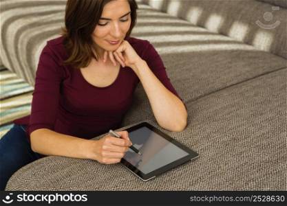 Gorgeous woman at home working with a tablet