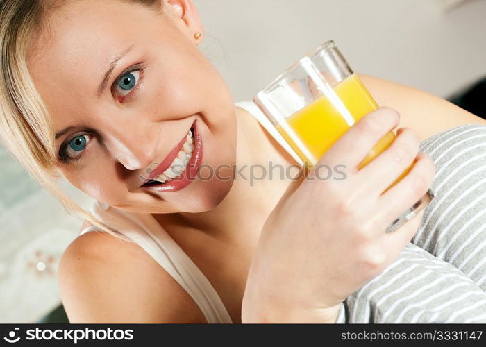 Gorgeous woman enjoying a glass of orange juice