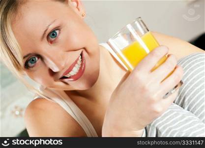 Gorgeous woman enjoying a glass of orange juice