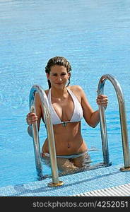 Gorgeous woman getting out of swimming pool