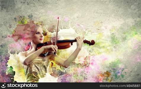 Gorgeous woman playing on violin. Image of beautiful female violinist playing against splashes background