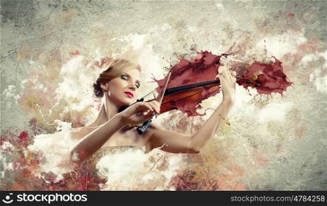 Gorgeous woman playing on violin. Image of beautiful female violinist playing with closed eyes against splashes background
