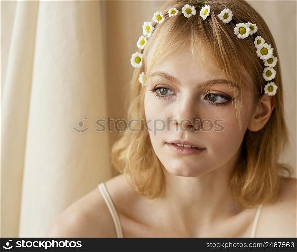 gorgeous woman posing while wearing delicate spring flowers crown