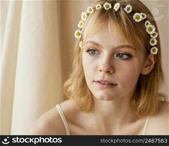 gorgeous woman posing while wearing delicate spring flowers crown
