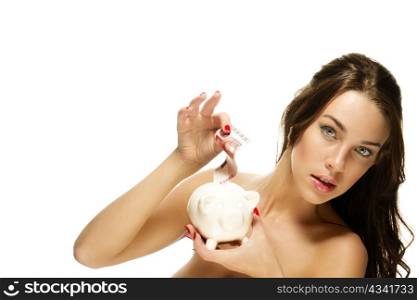 gorgeous woman put some money in her piggy bank. gorgeous woman put some money in her piggy bank on white background