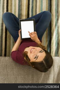 Gorgeous woman using a digital tablet indoors, with copy space