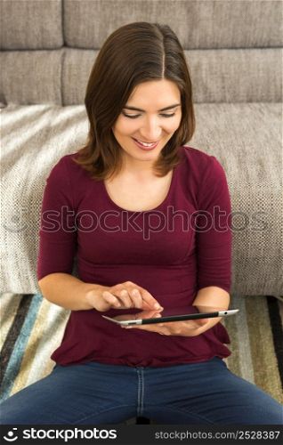 Gorgeous woman using a digital tablet indoors, with copy space