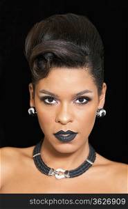 Gorgeous woman with black lipstick posing against black background