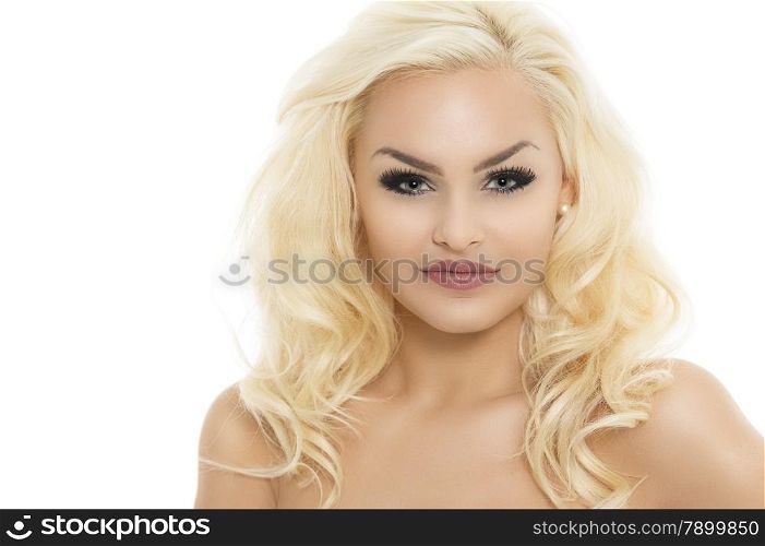 Gorgeous young blond woman with dark eye makeup and long curly hair posing with bare shoulders facing the camera with a smile, isolated on white