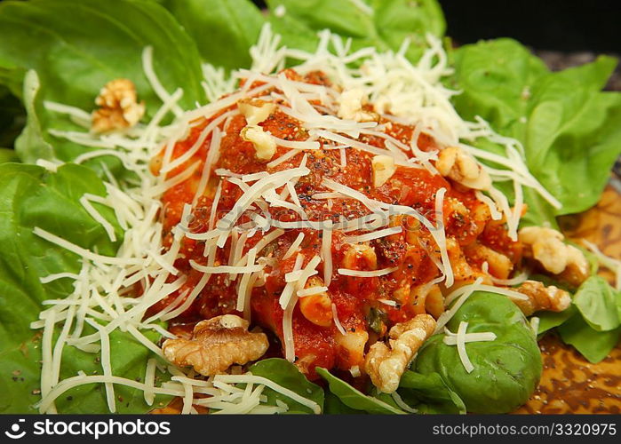 Gorgonzola, Italian blue cheese, with walnuts and basil rolled in lasanga noodles on a bed of spinach.