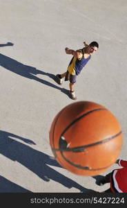 gorup of young boys who playing basketball outdoor on street with long shadows and bird view perspective