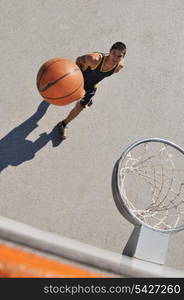 gorup of young boys who playing basketball outdoor on street with long shadows and bird view perspective