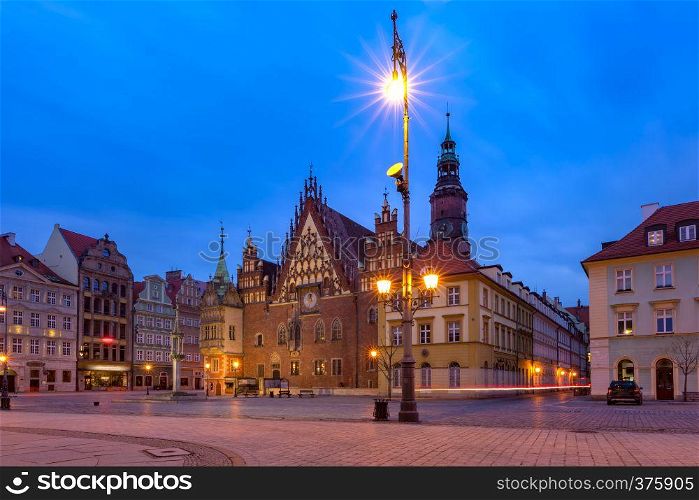 Gothic town hall and colorful houses on Market Square during morning blue hour in the Old Town of Wroclaw, Poland. City hall on Market Square in Wroclaw, Poland