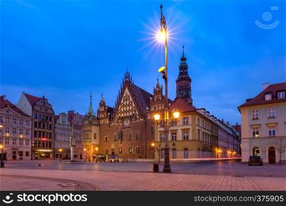 Gothic town hall and colorful houses on Market Square during morning blue hour in the Old Town of Wroclaw, Poland. City hall on Market Square in Wroclaw, Poland